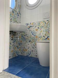 a bathroom with a sink and a toilet at Villa Azzurra in Marina di Mancaversa