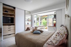 a teddy bear sitting on a bed in a bedroom at Marion plage in Cagnes-sur-Mer