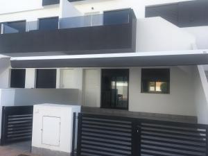 a house with a black and white facade at Casa Escocesa in San Pedro del Pinatar