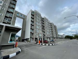 an empty parking lot with two tall apartment buildings at Langkawi Simfoni Beliza Apartment with Sky Pool by Zervin in Kuah