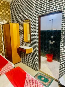 a bathroom with a sink and a mirror at Hotel Bengal in Kolkata