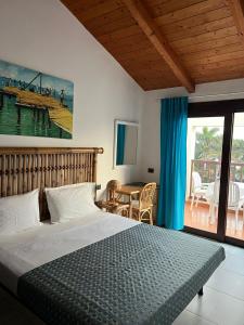 a bedroom with a bed and a view of a deck at Apt71 Porto Antigo 2 in Santa Maria