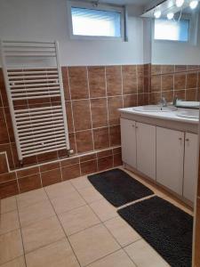 a bathroom with a sink and a mirror at Le Presbytère de la côte d'opale in Nempont-Saint-Firmin