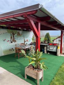 a patio with a picnic table and a grill at Kata apartment in Tolna