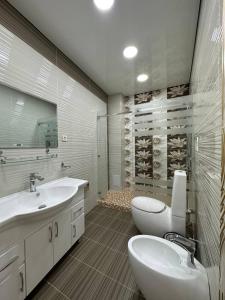 a bathroom with two sinks and a wine cellar at Grand Nodirbek Boutique Hotel in Bukhara
