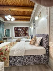 a bedroom with a large bed in a room at Grand Nodirbek Boutique Hotel in Bukhara