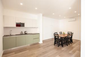 a kitchen and dining room with a table and chairs at Lemon's Apartment in Elmas