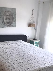 a bedroom with a bed with a statue on the wall at 4 bed house, Private Pool near Beach in Burriana +23 photos