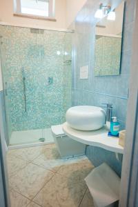 a bathroom with a shower and a toilet and a sink at Villa Bianca in Tramonti +35 photos