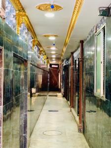 einen Flur in einem alten Gebäude mit Glaswänden in der Unterkunft Hotel Bengal in Kalkutta