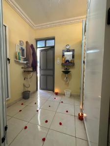 a bathroom with a tile floor with red flowers on it at Hostel World Rooftop Marrakech in Marrakesh