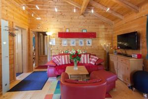 a living room with a red couch and a table at Ferienhaus Bayerischer Wald in Stamsried