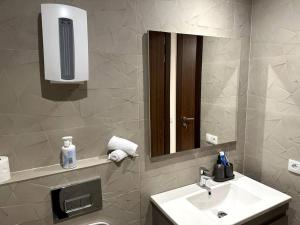 a bathroom with a sink and a mirror at Cozy Elegant Apartment in Casablanca in Casablanca