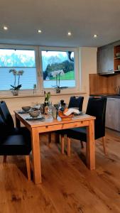 a wooden table in a kitchen with chairs around it at Kalvarienberg Appartement Gosau in Gosau