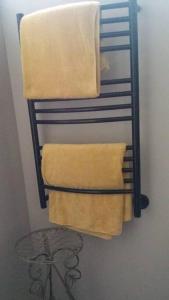 a towel rack with towels on it in a bathroom at Serenity 465 in De Kelders