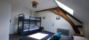 a bedroom with two bunk beds in a attic at Gîte La Grange 9 pers in Saint-Georges-sur-Cher