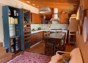 a kitchen with a table and a couch in a room at Chalet Leonard House in the wood in Pennabilli +23 photos