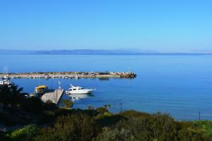 a group of boats docked in a large body of water at Sunrise Studios in Megalochori