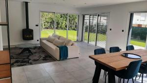 a living room with a couch and a table at L'Aurore du Lac in Sévrier