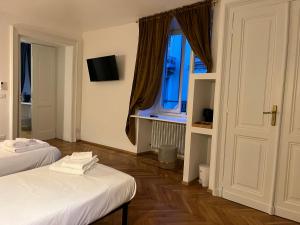 una camera con due letti e una finestra di Turin Central Suite a Torino