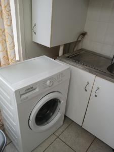 a washer and dryer in a small kitchen at house in the village near the sea in Maleme