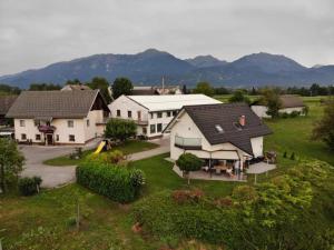 an aerial view of a house with mountains in the background at Guest house TOMAN in Bled