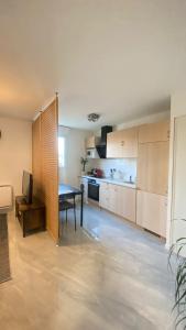 a large kitchen with a ping pong table in it at Studio Moderne au Victor Hugo in Les Mureaux