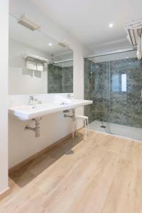 a bathroom with a large white sink and a shower at Hotel Leal - La Sirena in Villanueva de Arosa