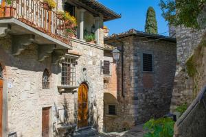 an old stone building with a door and a balcony at Bonaventura in Greve in Chianti