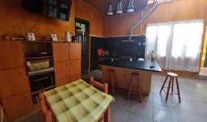 a kitchen with a counter and a table and a counter top at Hostal Playa Ancha in Valparaíso