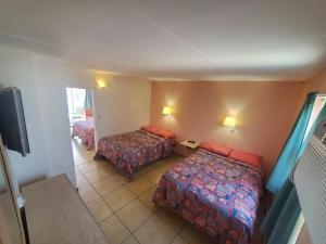 Postel nebo postele na pokoji v ubytování Caprice Motel - Wildwood