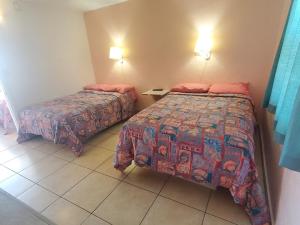 Postel nebo postele na pokoji v ubytování Caprice Motel - Wildwood