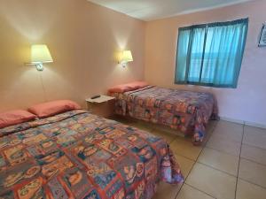 Postel nebo postele na pokoji v ubytování Caprice Motel - Wildwood
