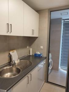 a kitchen with a sink and white cabinets at Apartamento bonito - playas las Deveses in El Verger