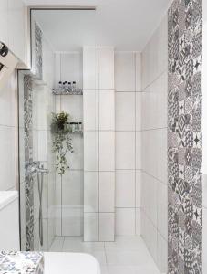 a white bathroom with a shower and a sink at Jasmine Loft Luxury 2 in Kokkíni Khánion