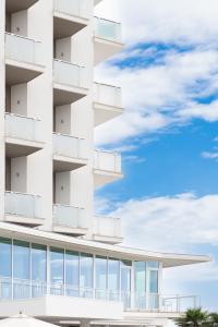 a building with balconies and a blue sky at Hotel Mexico in Bellaria-Igea Marina