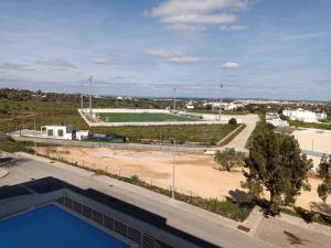 a view of a soccer field and a road at Casa dos Avós - Quinas II in Armação de Pêra