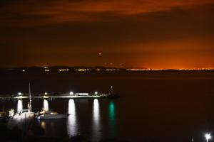 a view of a harbor at night with boats in the water at Sunrise Studios in Megalochori