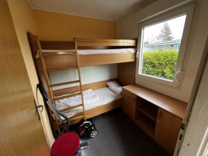 ein kleines Zimmer mit Etagenbetten und einem Fenster in der Unterkunft Mona in Graal-Müritz