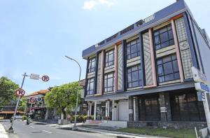 a building on the corner of a street at Moreno Homestay in Legian