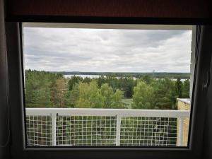 a window with a view of a forest of trees at Studio Apartment with Lake View in Visaginas