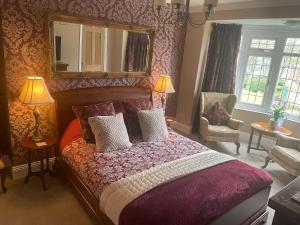 a bedroom with a large bed and a mirror at Park View in Scarborough