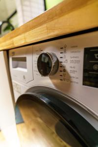 a close up of a washing machine under a counter at Spacious 80m2 Private House, central Tokyo in Tokyo