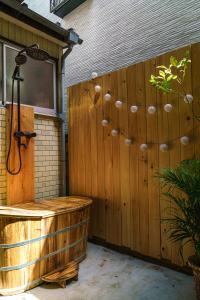 a wooden privacy fence with a jacuzzi in a backyard at Spacious 80m2 Private House, central Tokyo in Tokyo
