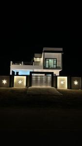 a night view of a house with lights in front of it at استراحة المرجان 