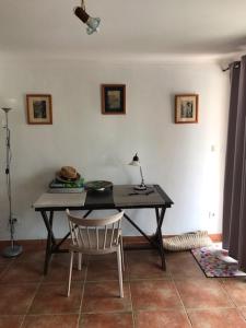 a table and a chair in a room at Studio de 39 m2 in Vezzani