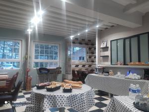 a room with two tables with food on them at Le Cardinal B&B in Annebault