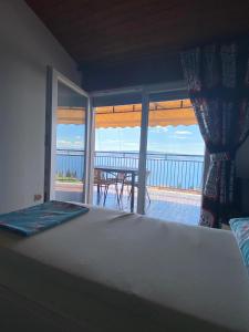 a bedroom with a bed and a view of the ocean at Apartments Drazen in Crikvenica