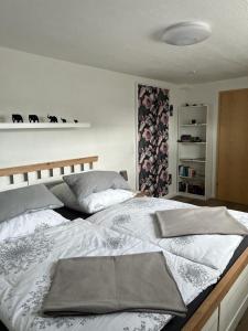 a bedroom with a large bed with white sheets at Ferienwohnung Jardin de lavande in Fridingen an der Donau