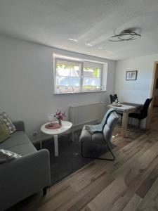 a living room with a couch and a table at Ferienwohnung Jardin de lavande in Fridingen an der Donau